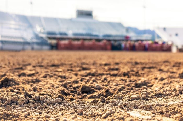 Freshly raked dirt arena ready for riders.